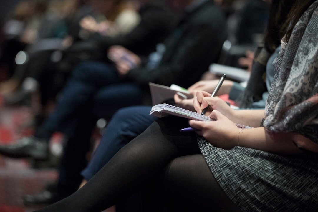 Business training workshop with people taking notes